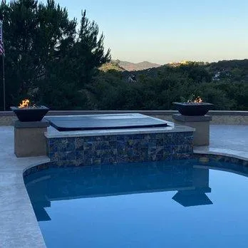 Modern pool with spa and fire features